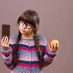 girl choosing between candy and apple