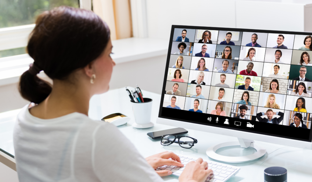 woman is facing desktop computer with gallery view of 36 other adults who are attending professional development for teachers.