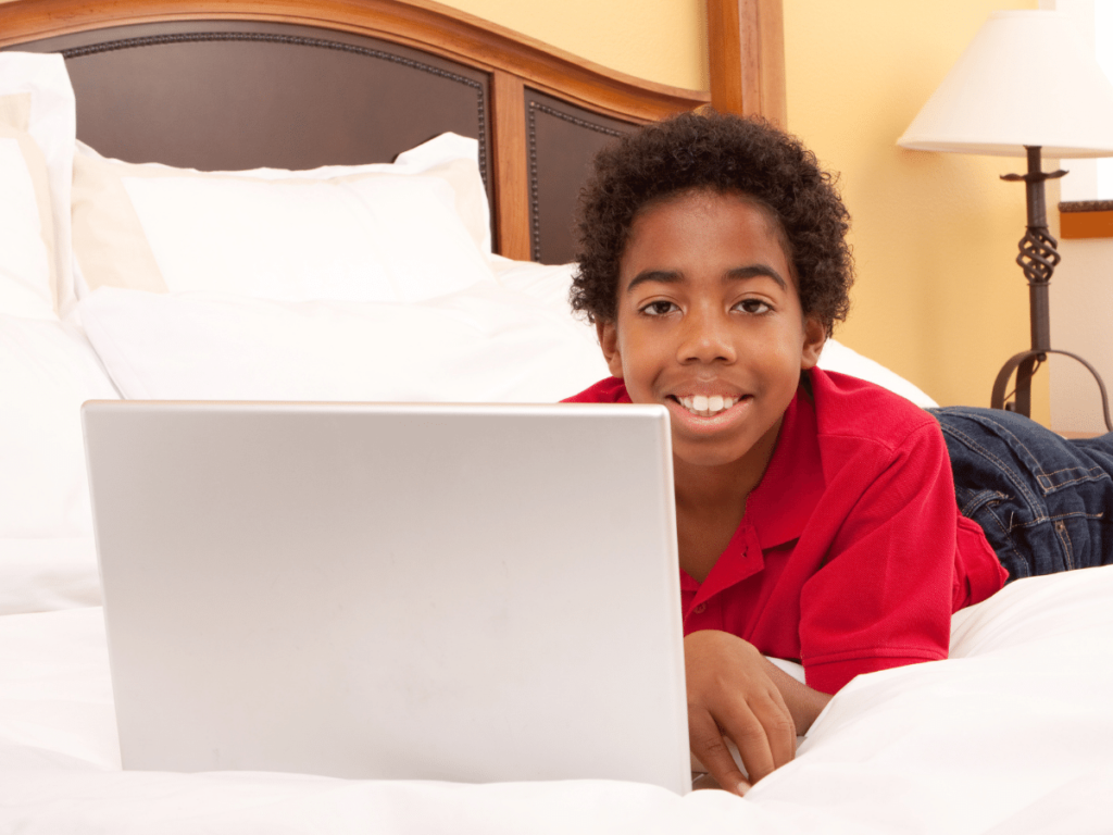 boy using laptop to participate in virtual learning