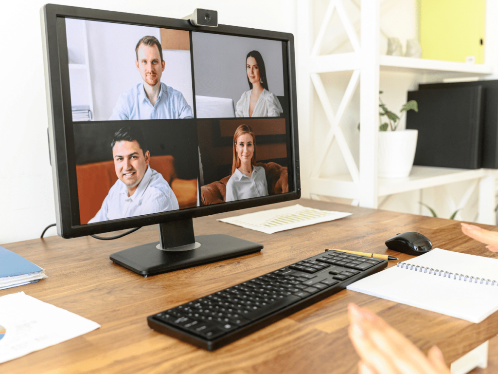 computer monitor showing 4 people in a virtual meeting breakout room