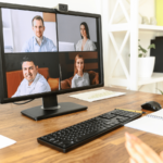 computer monitor showing 4 people in a virtual meeting breakout room
