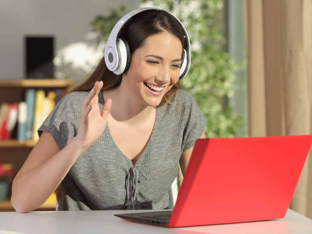 female raising hand and interacting with other students in a virtual breakout room on a laptop