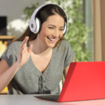 female raising hand and interacting with other students in a virtual breakout room on a laptop