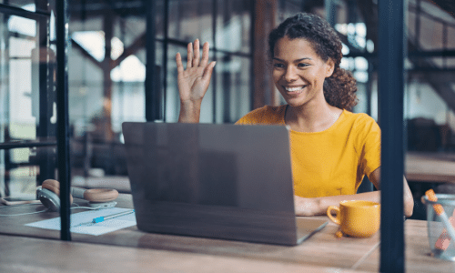 young African American female teacher using her laptop to interact with virtual learners