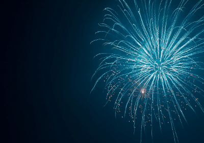 black background with large blue fireworks in upper right corner