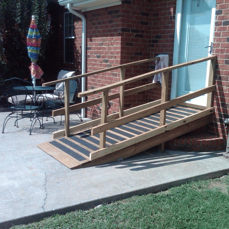 a wheelchair ramp leading up to the door of a home