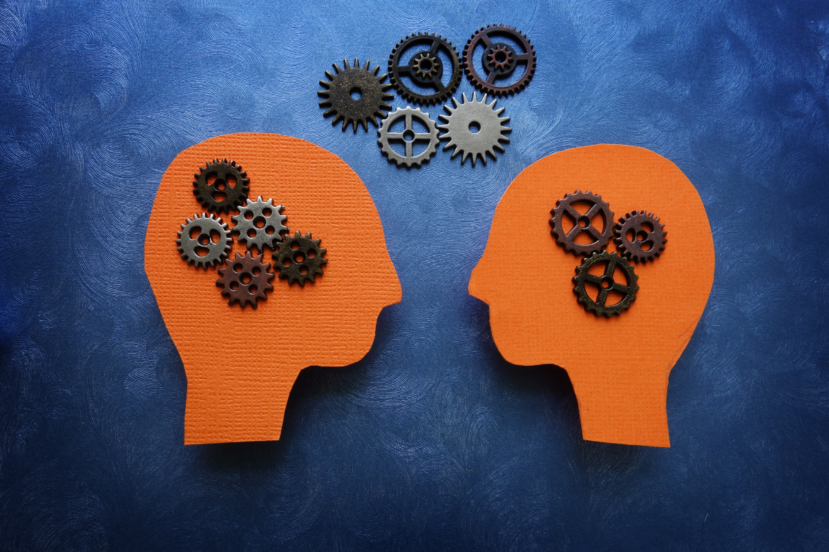 blue background, 2 orange human heads with a variety of gears signifying thinking and sharing ideas