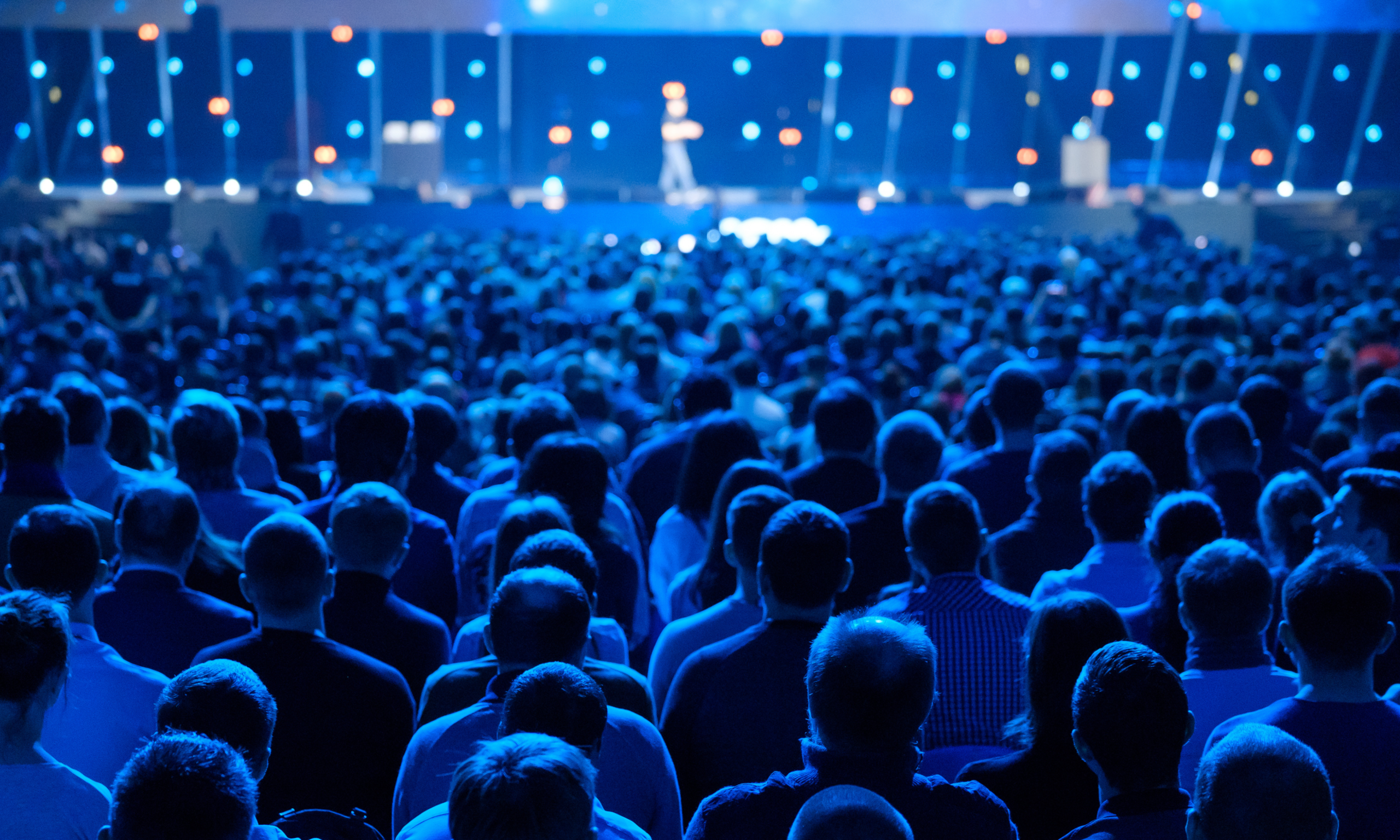 large conference audience tinted blue