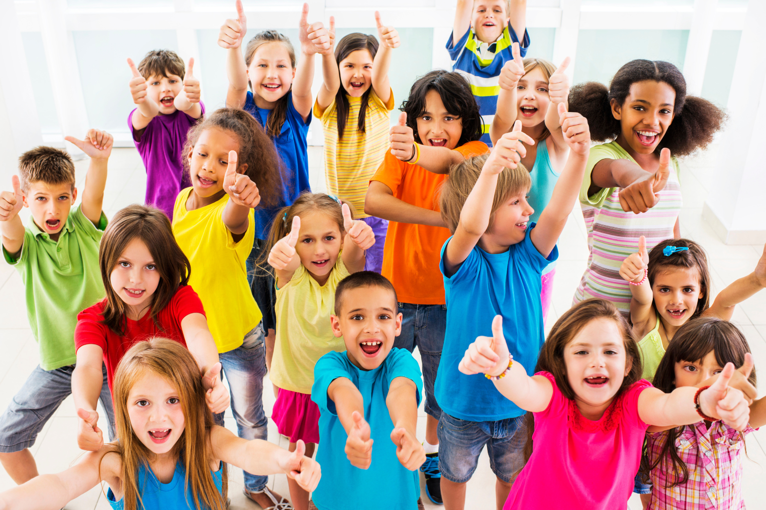 variety of children giving thumbs up gestures