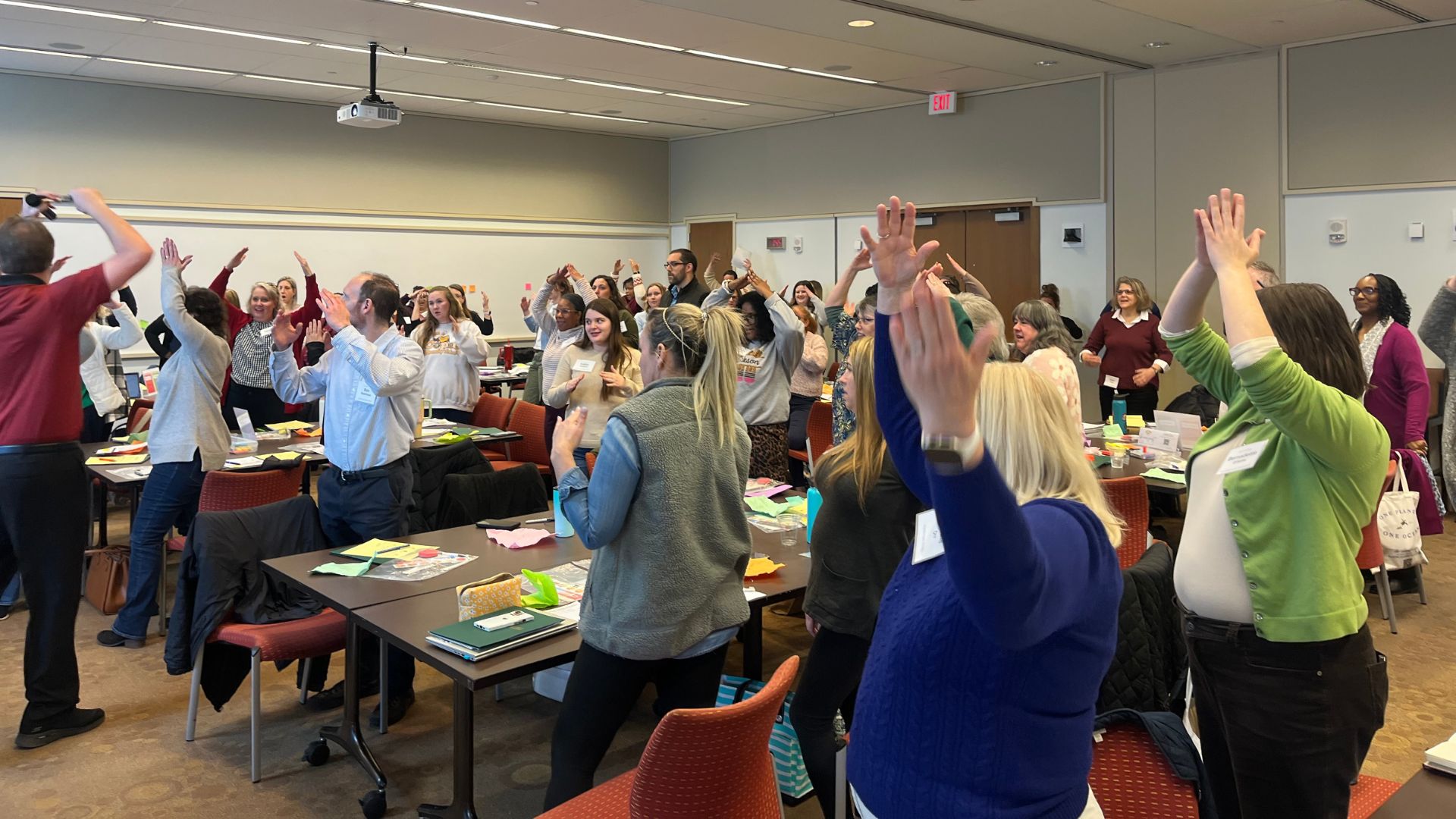room full of teachers practicing a gestural response